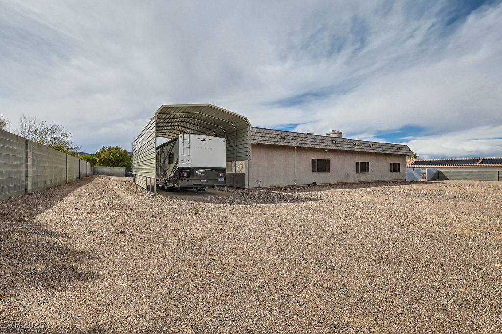 647 Foxhall Road Henderson, NV 89002 - Photo 74 of 82 View of outdoor structure with dirt driveway, fence, and a carport