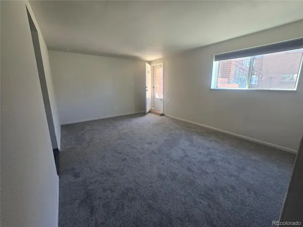 a view of an empty room and a window