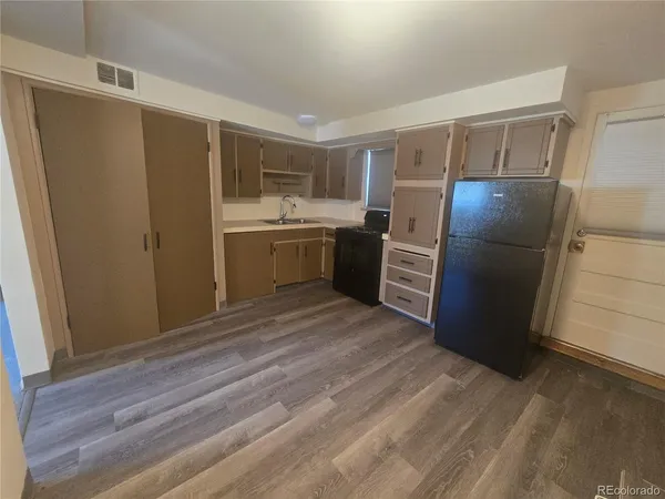 a kitchen with a refrigerator and a sink