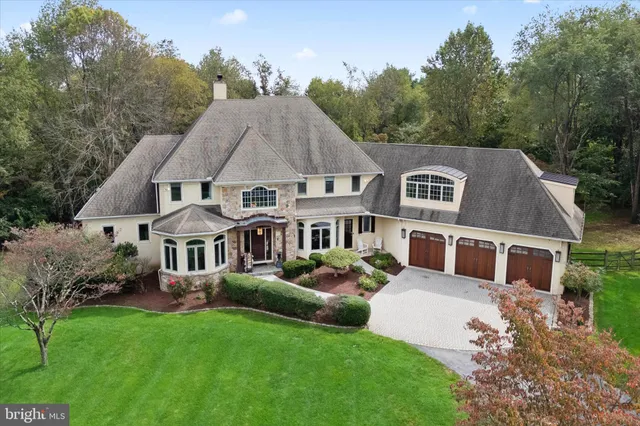 a aerial view of a house with swimming pool and next to a yard
