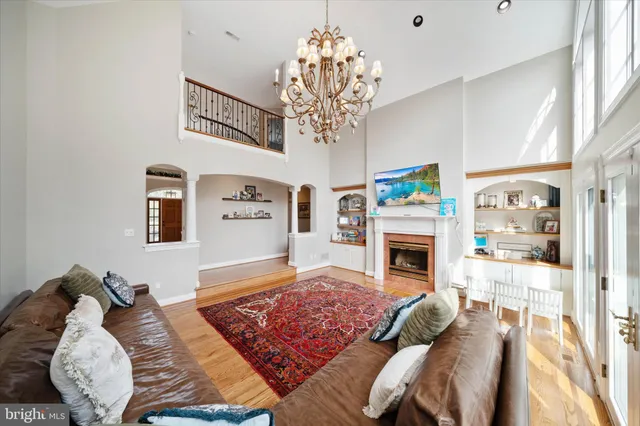 a living room with furniture large window and a fireplace