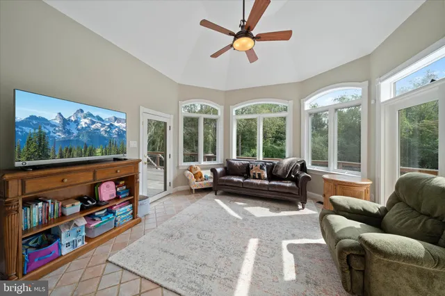 a kitchen with stainless steel appliances granite countertop a table chairs sink and cabinets
