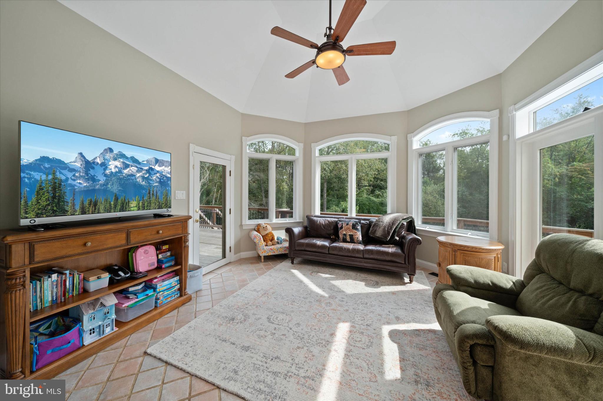 1540 Fairville Road Chadds Ford, PA 19317 - Photo 18 of 86 a living room with furniture a flat screen tv and a floor to ceiling window