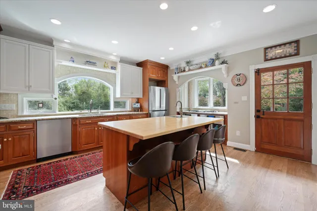 a kitchen with stainless steel appliances a refrigerator sink and cabinets