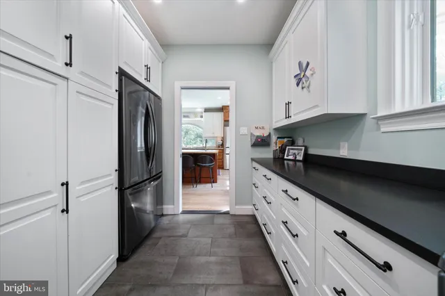 a bathroom with a granite countertop sink mirror and shower
