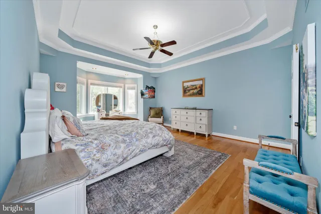 a bedroom with two beds and painting on the wall