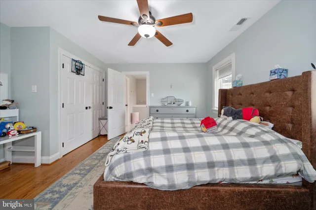 a bedroom with a bed and a dresser