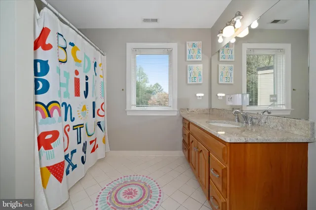 a bathroom with a sink mirror and shower