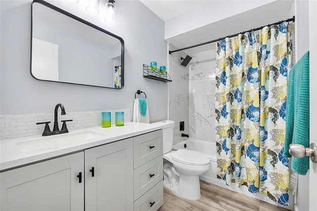 a bathroom with a sink toilet and shower