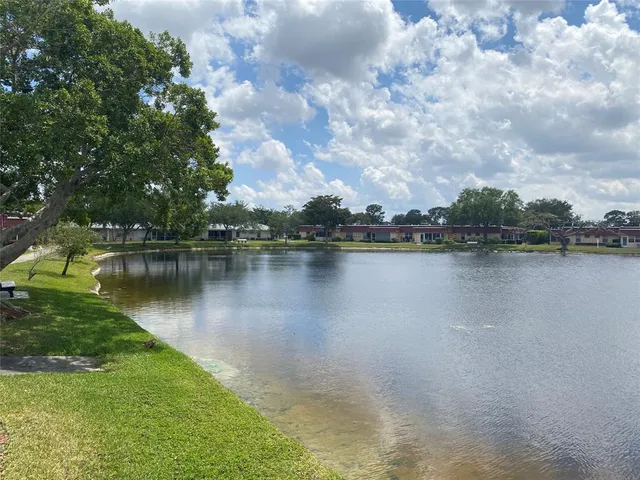 a view of a lake with houses in the back
