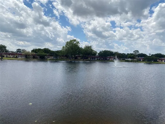 a view of a lake with houses in the back