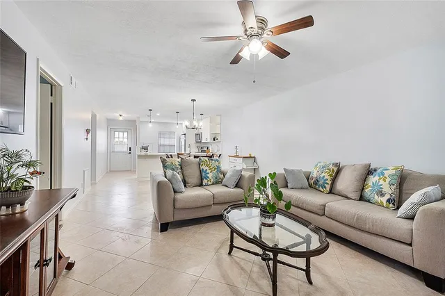 a living room with furniture and kitchen view