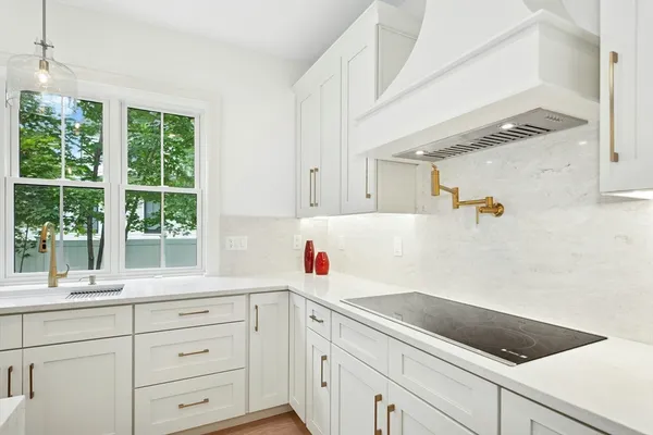 a kitchen with a sink and large window