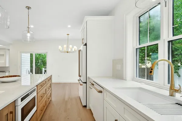 a bathroom with a double vanity sink a mirror and a bathtub