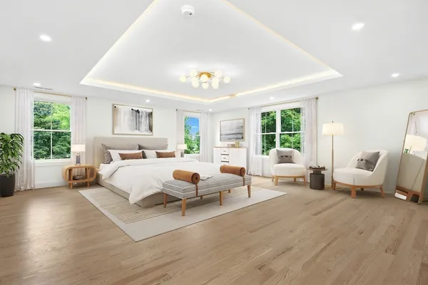 a spacious bedroom with a bed and wooden floor