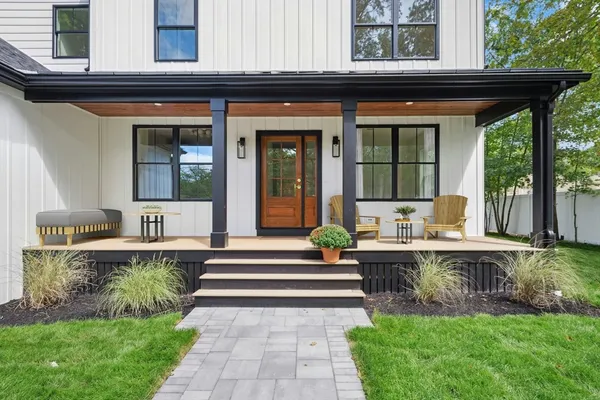 a front view of a house with a yard table and chairs