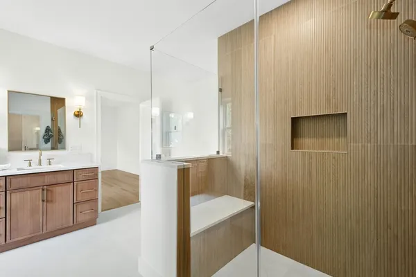 a bathroom with a sink a mirror and a bathtub
