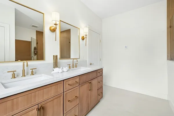 a bathroom with a double vanity sink and mirror