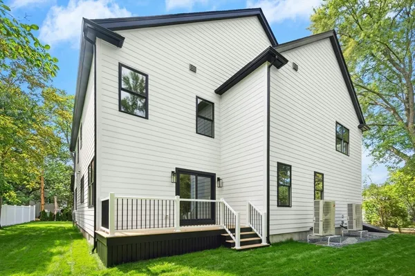 a view of a house with a yard and deck