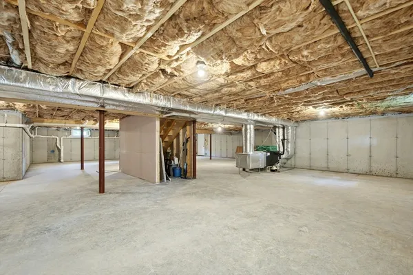 a view of a big room with an empty space and wooden deck