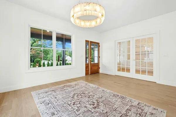an empty room with wooden floor and a window