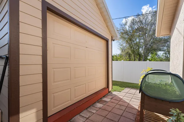 a view of a patio with a table and chairs under an umbrella