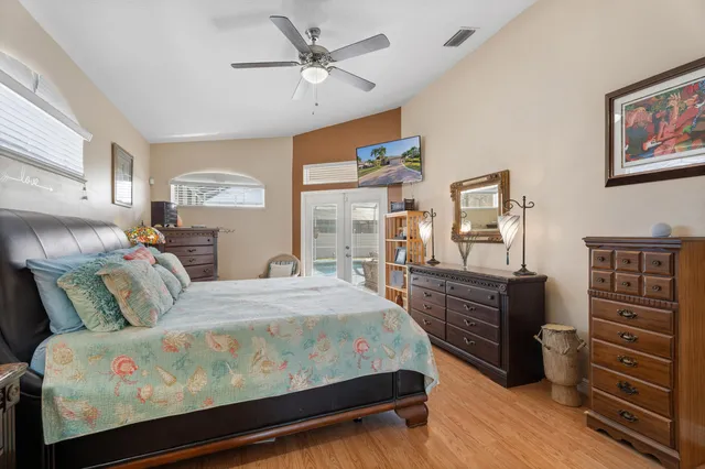 a bedroom with a bed and a chandelier