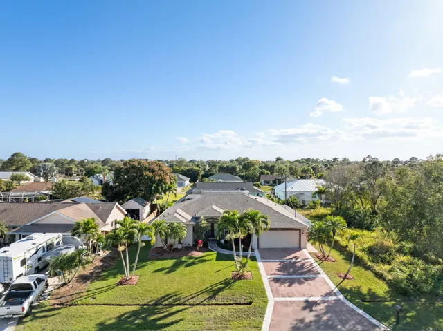an aerial view of a house with a yard and potted plants