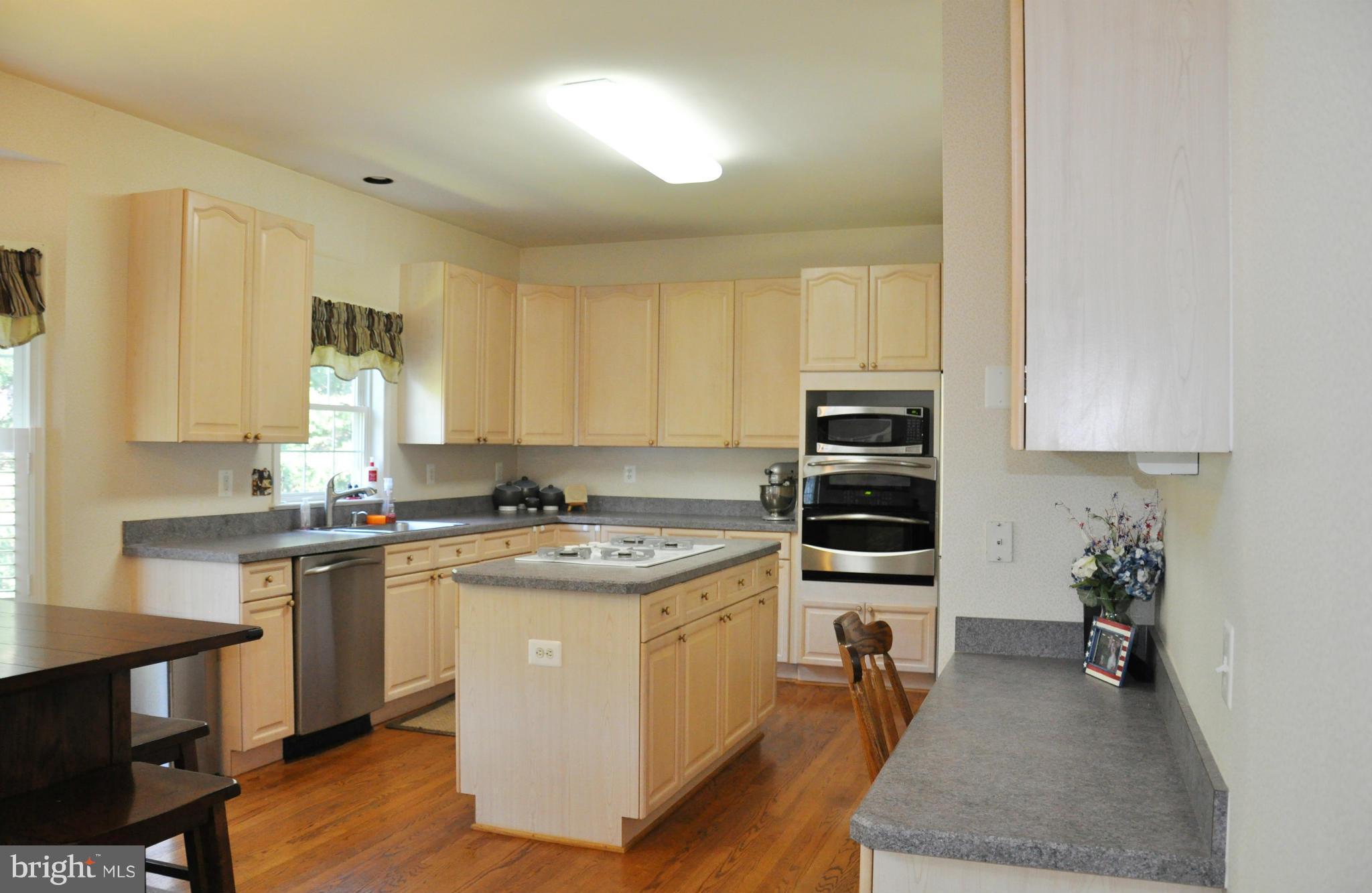 2585 Bear Den Road Frederick, MD 21701 - Photo 14 of 30 a kitchen with a stove a sink and a refrigerator