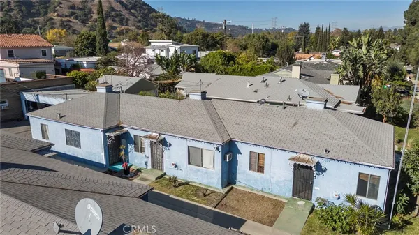 a aerial view of multiple houses with yard
