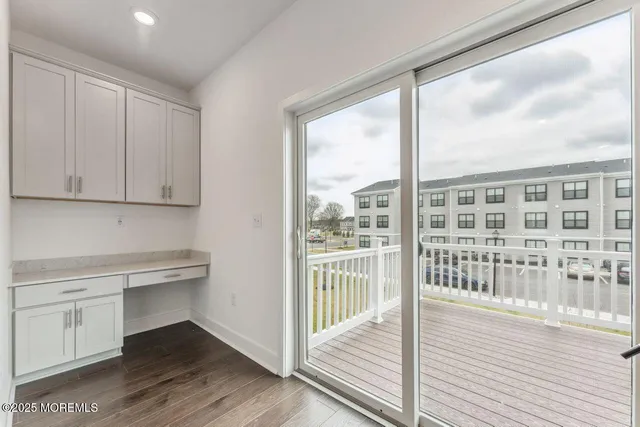a view of a kitchen with wooden floor and a window
