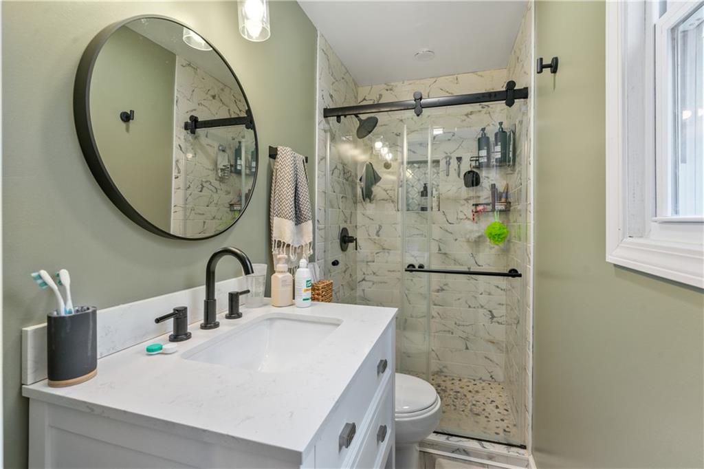 139 William Circle McKees Rocks, PA 15136 - Photo 15 of 24 a bathroom with a sink a mirror and a shower