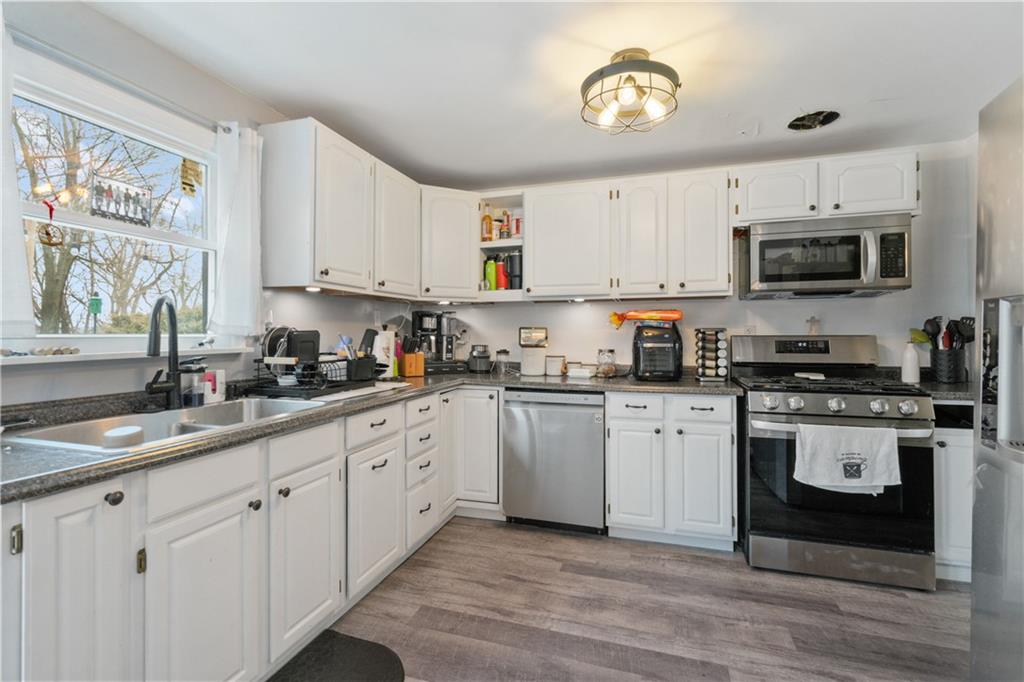 139 William Circle McKees Rocks, PA 15136 - Photo 10 of 24 a kitchen with granite countertop a sink stainless steel appliances and white cabinets