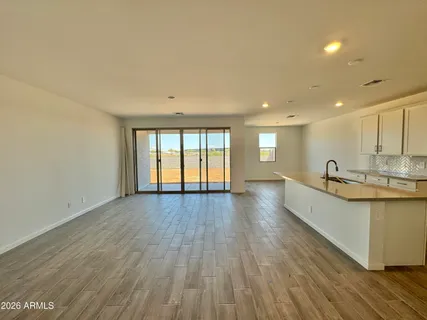 a view of kitchen with sink and wooden floor