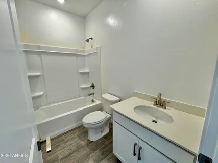 a bathroom with a sink toilet a mirror and shower