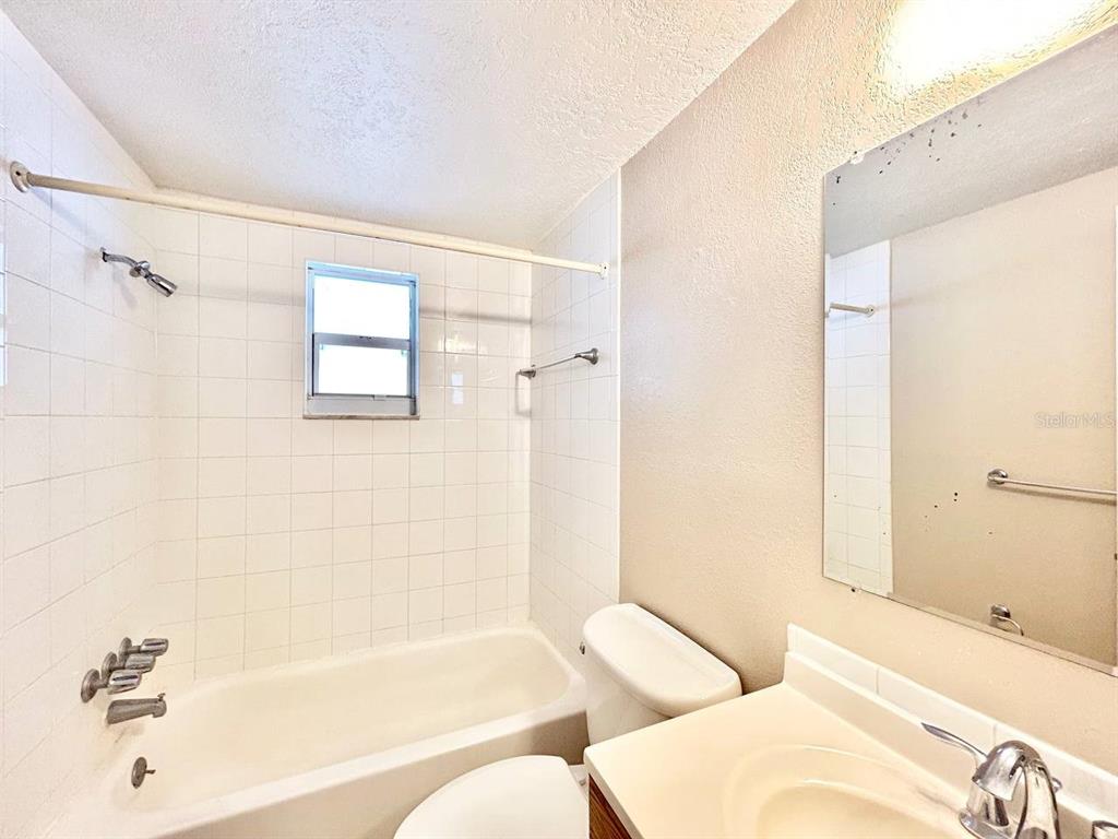 5805 Delaware Avenue New Port Richey, FL 34652 - Photo 8 of 12 a bathroom with a bathtub and a shower