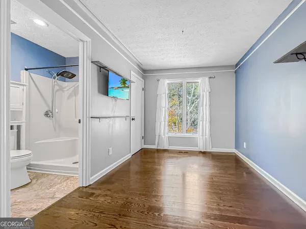 a bathroom with a toilet sink and shower
