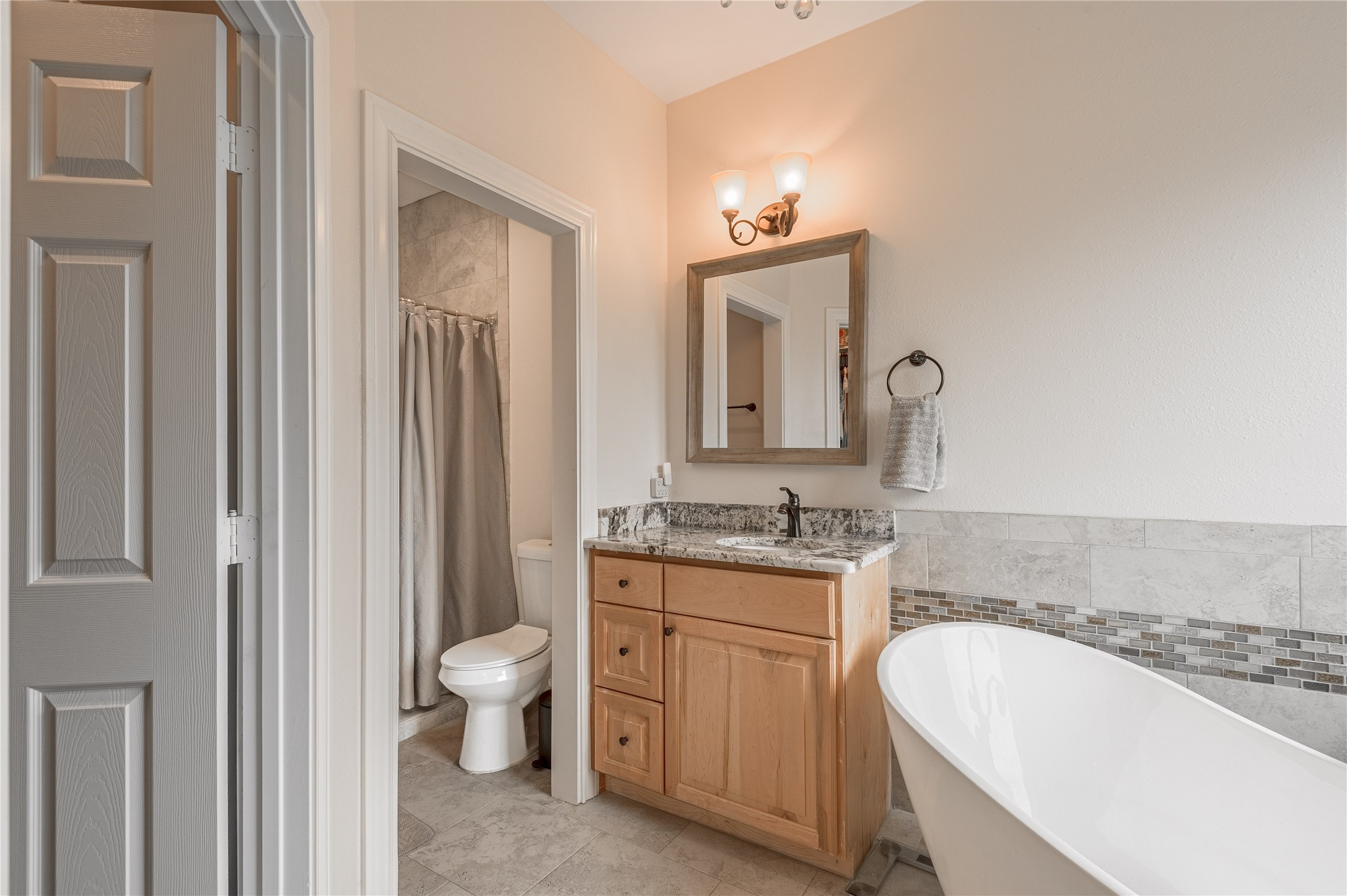 2803 Fm 2158 Midway, TX 75852 - Photo 22 of 49 a bathroom with a granite countertop sink a toilet and a mirror
