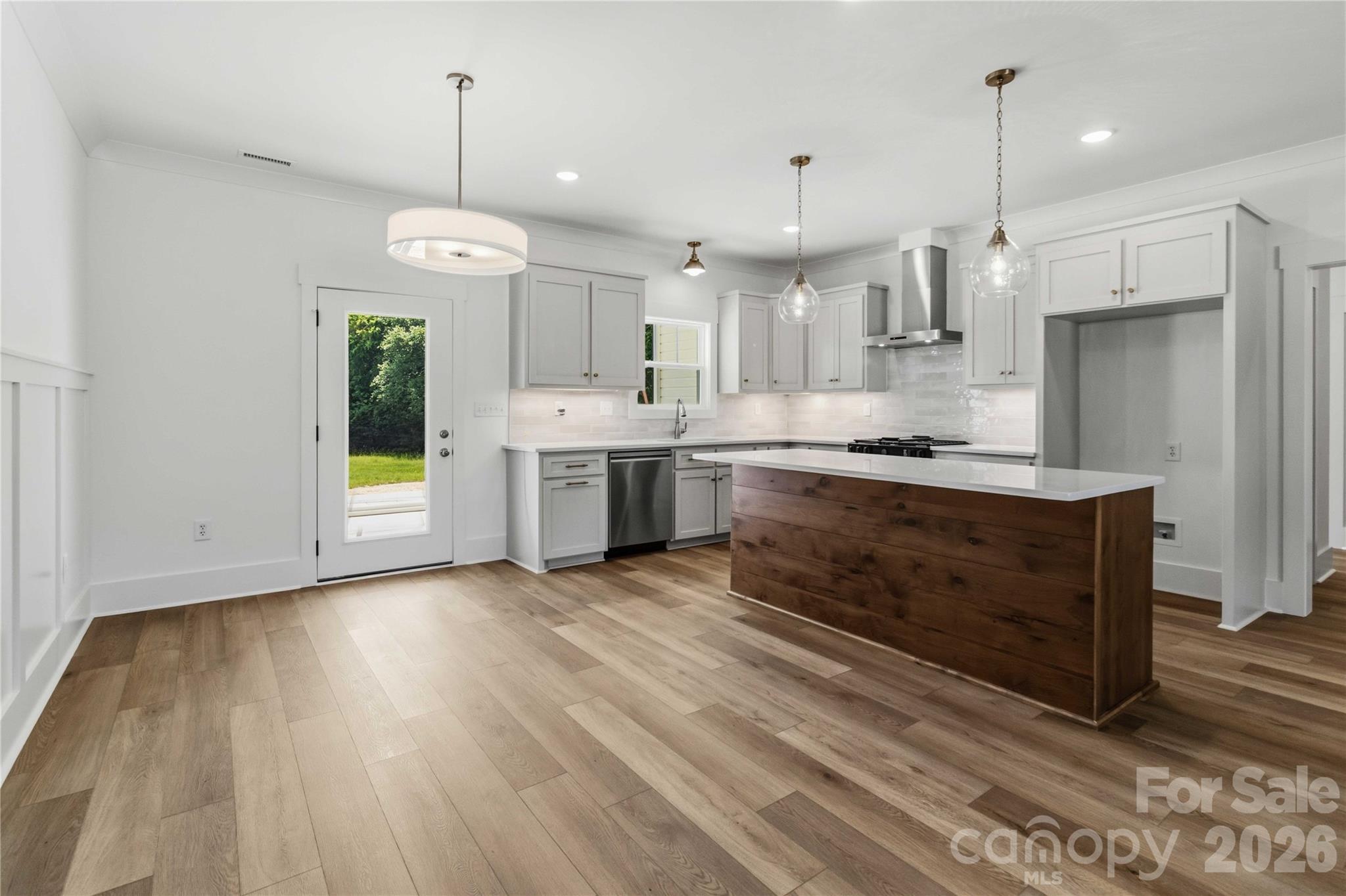 352 Adams Road Clover, SC 29710 - Photo 7 of 38 a large kitchen with stainless steel appliances granite countertop a stove and a wooden floors