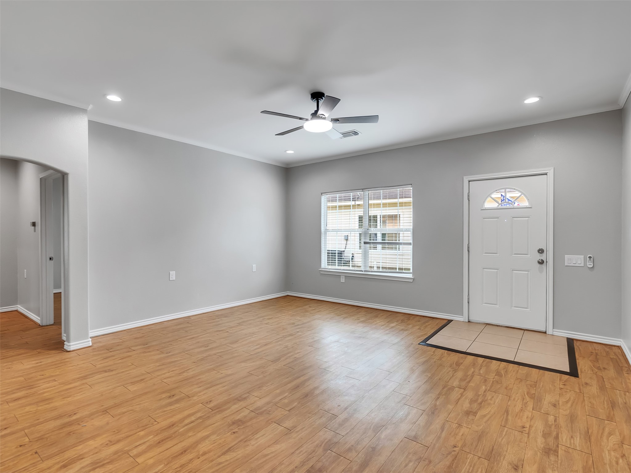 104 Longstreet Road, Unit 2 Willis, TX 77378 - Photo 10 of 26 an empty room with wooden floor chandelier fan and windows