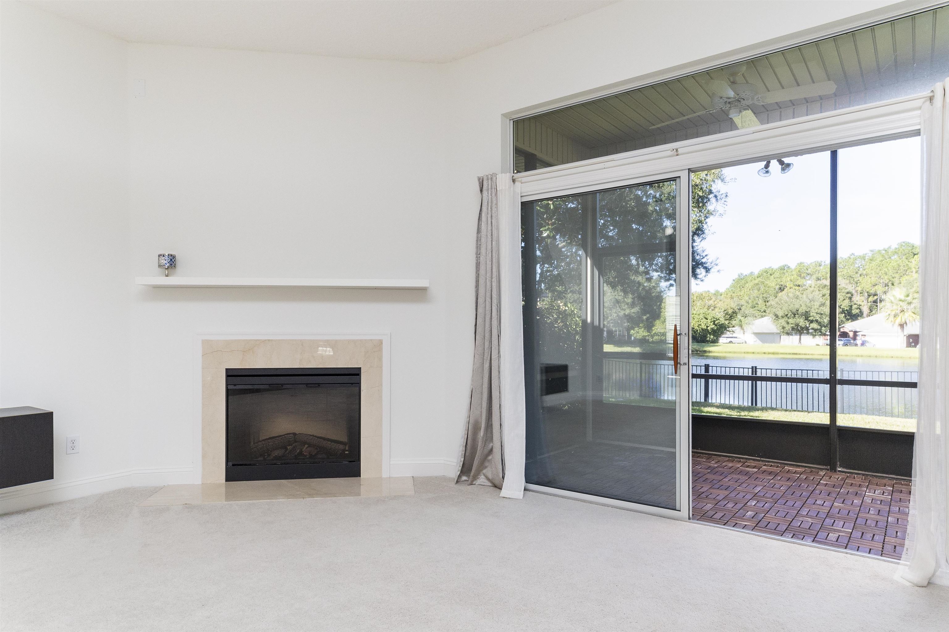145 Whisper Ridge Drive St. Augustine, FL 32092 - Photo 16 of 43 an empty room with floor to ceiling window and an outdoor view