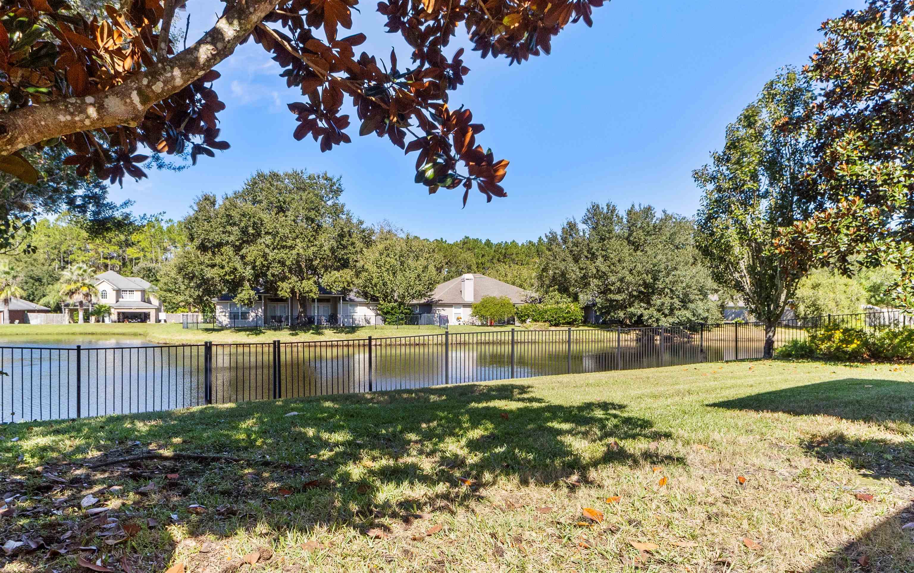 145 Whisper Ridge Drive St. Augustine, FL 32092 - Photo 2 of 43 a view of a lake with a big yard