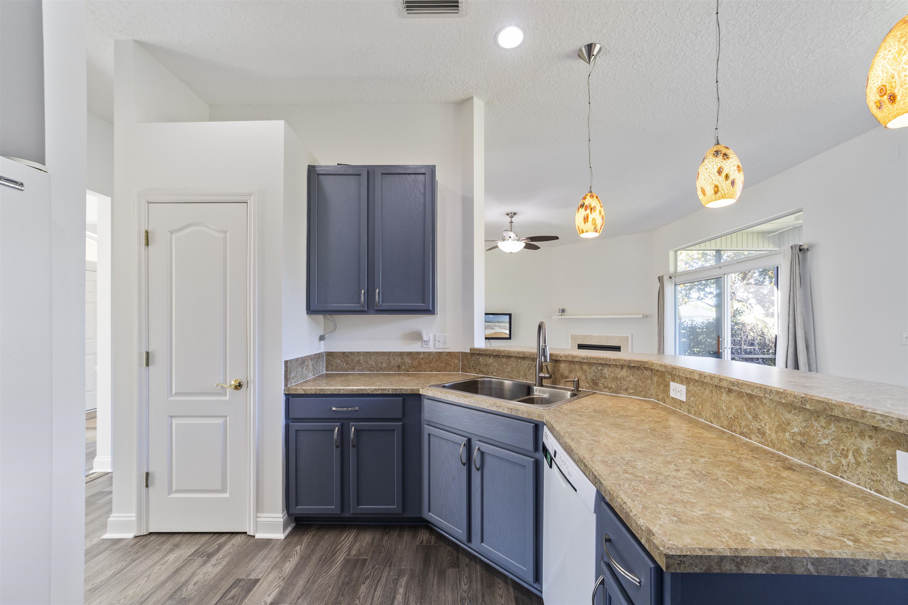 145 Whisper Ridge Drive St. Augustine, FL 32092 - Photo 24 of 43 a kitchen with granite countertop wooden cabinets and a sink