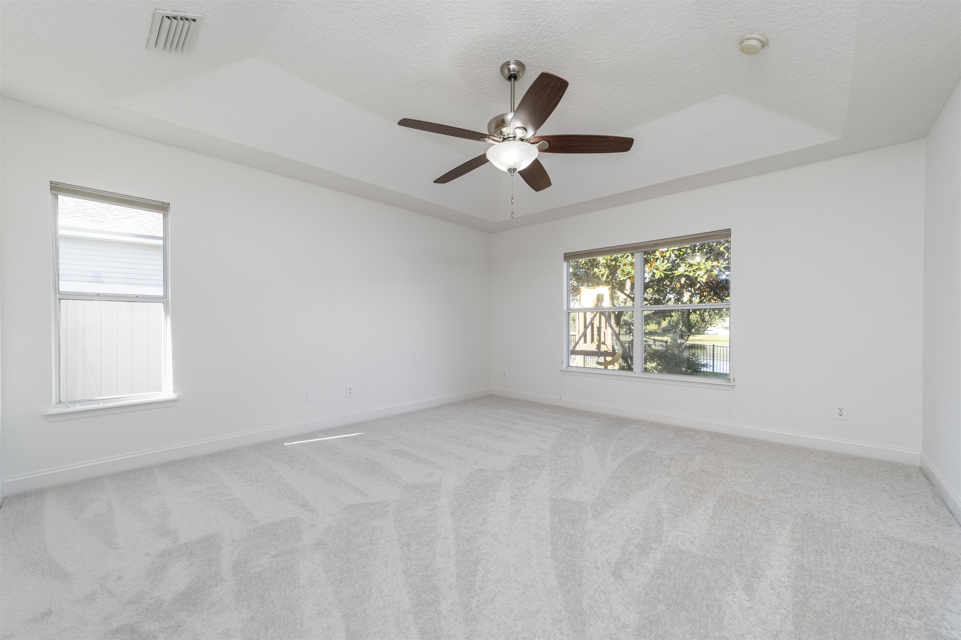 145 Whisper Ridge Drive St. Augustine, FL 32092 - Photo 26 of 43 an empty room with windows and ceiling fan