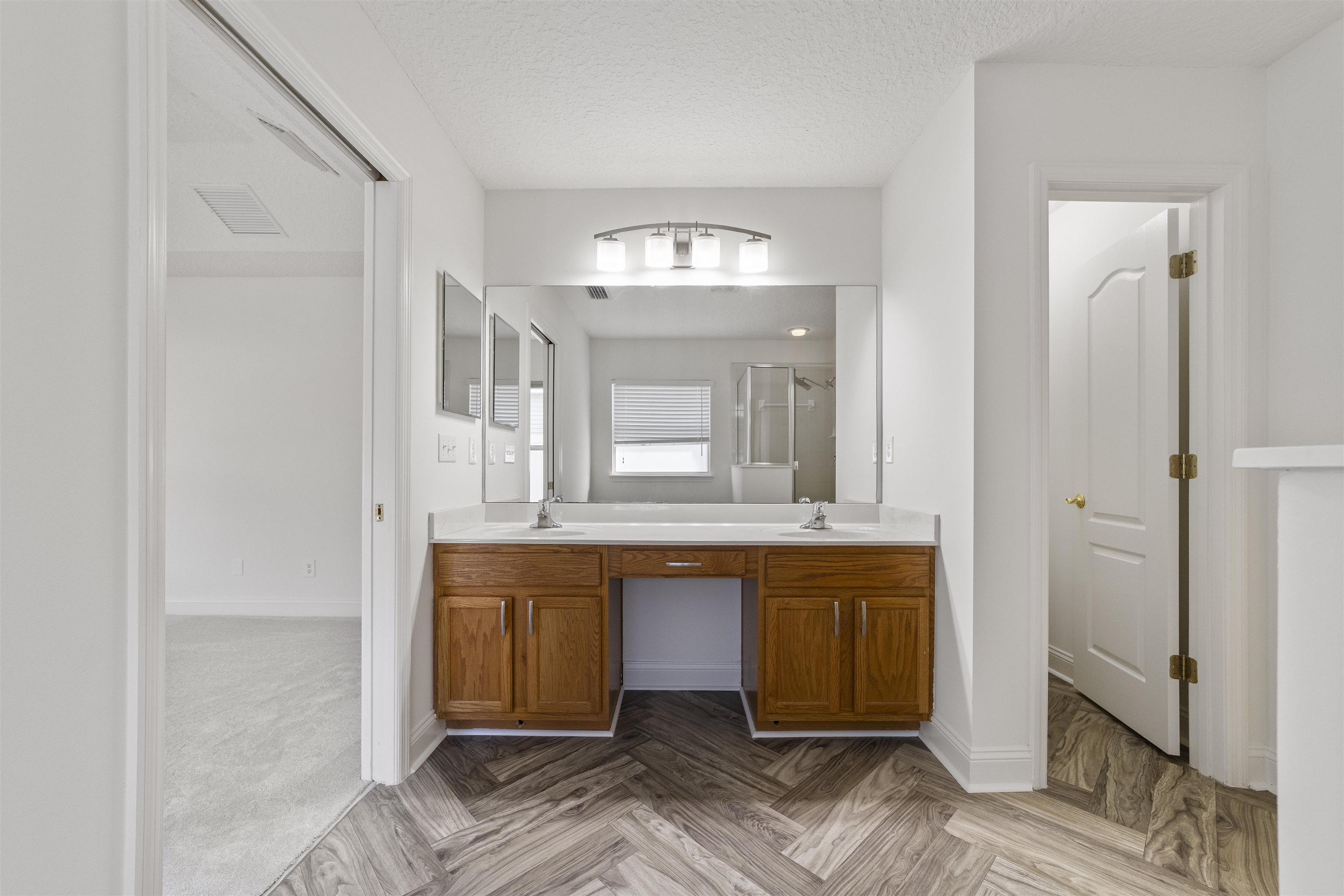 145 Whisper Ridge Drive St. Augustine, FL 32092 - Photo 29 of 43 a spacious bathroom with a sink and a mirror