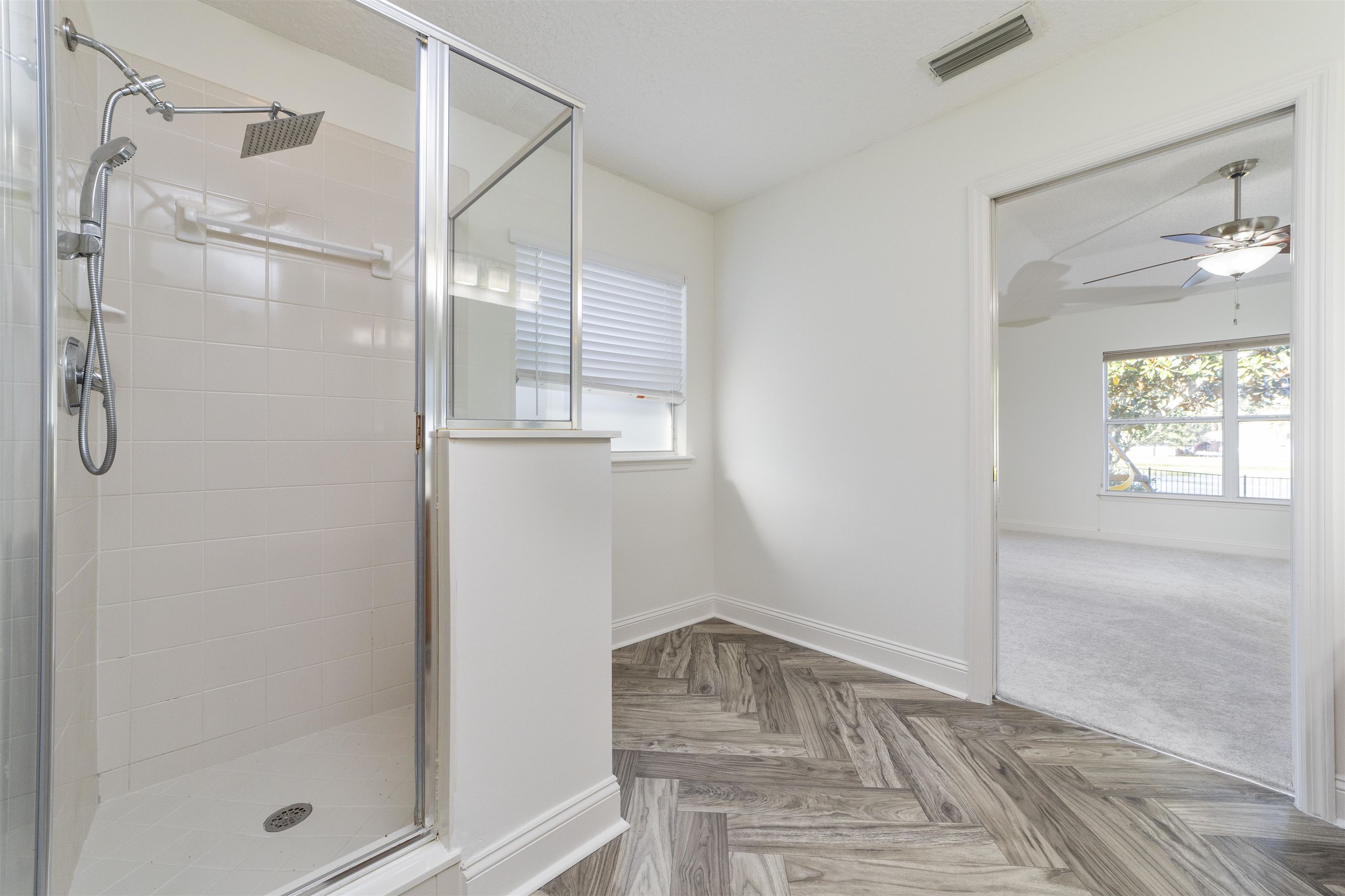 145 Whisper Ridge Drive St. Augustine, FL 32092 - Photo 30 of 43 a room that has a glass door shower