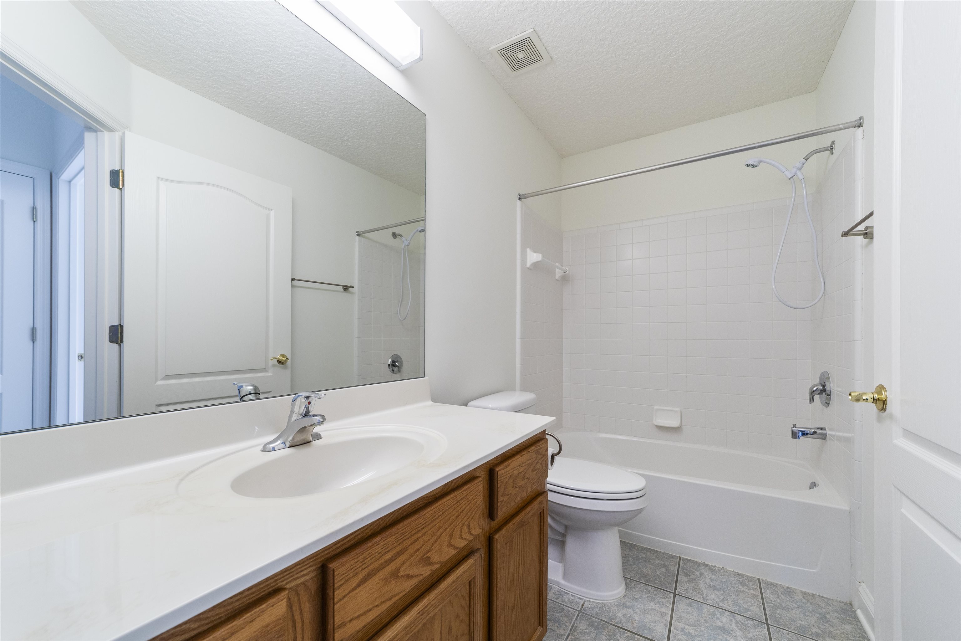 145 Whisper Ridge Drive St. Augustine, FL 32092 - Photo 34 of 43 a bathroom with a sink a toilet and a large mirror