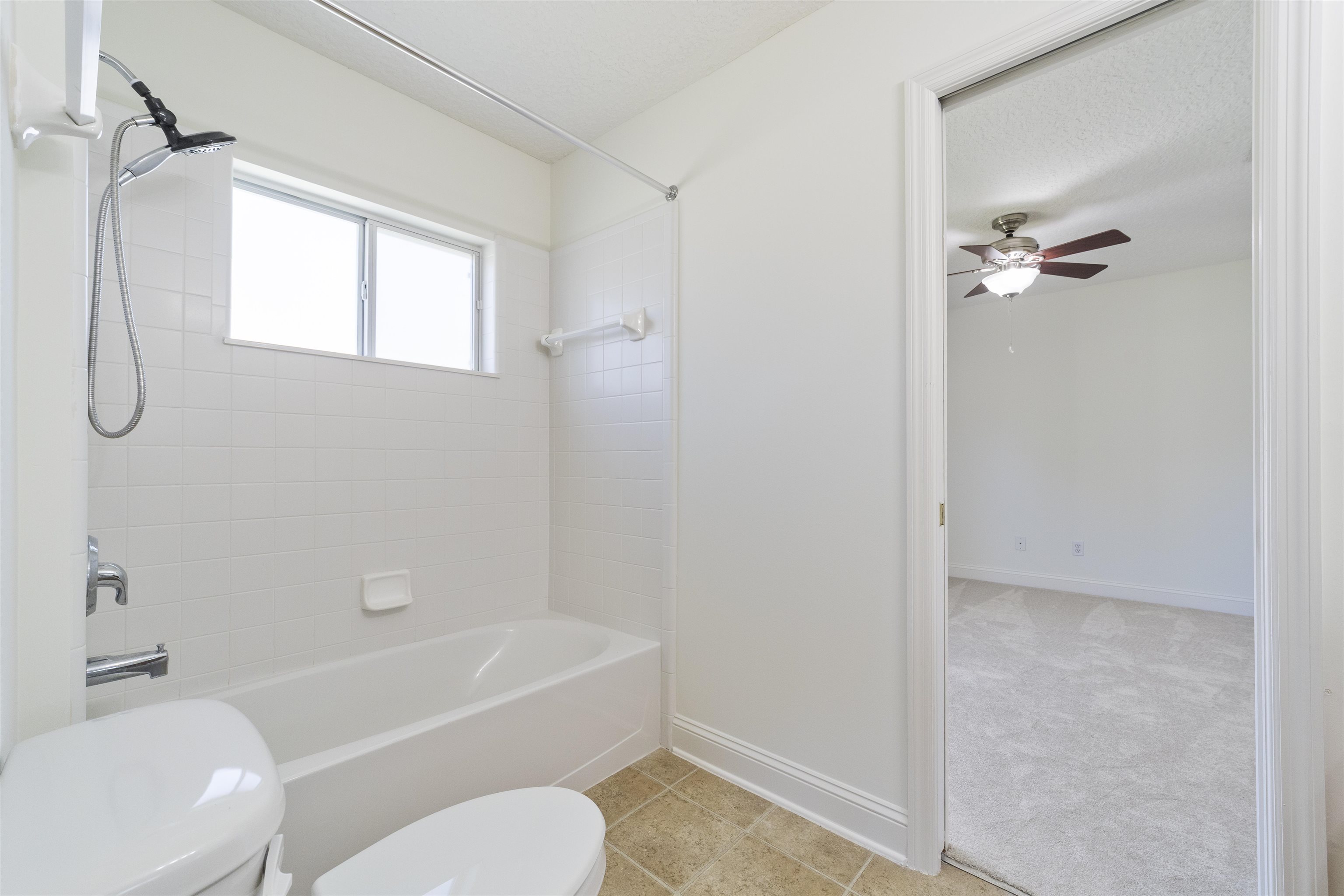145 Whisper Ridge Drive St. Augustine, FL 32092 - Photo 38 of 43 a bathroom with a toilet a sink and a bathtub