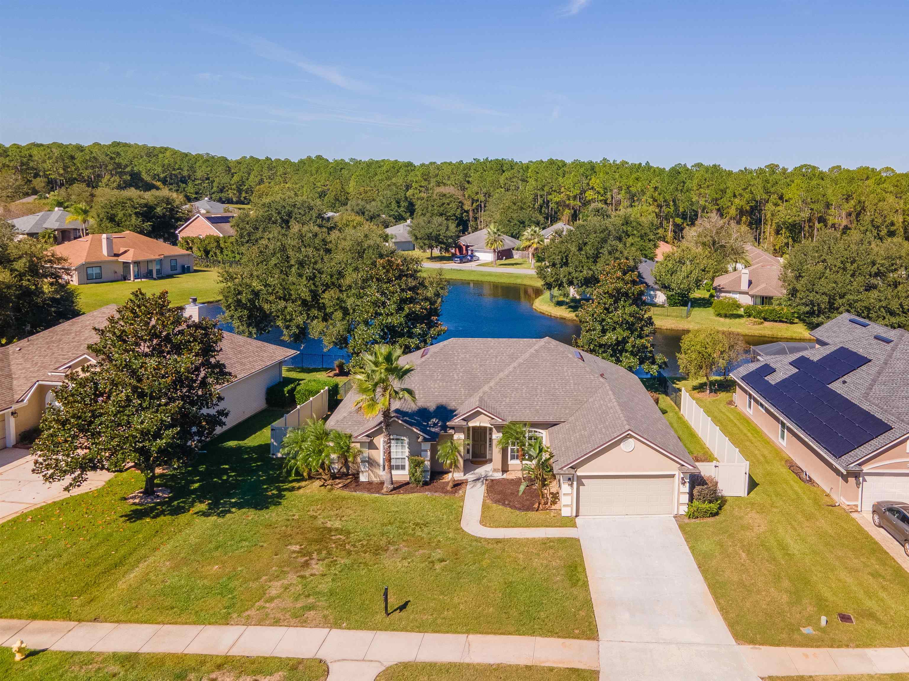 145 Whisper Ridge Drive St. Augustine, FL 32092 - Photo 42 of 43 a view of a swimming pool with a table and chairs