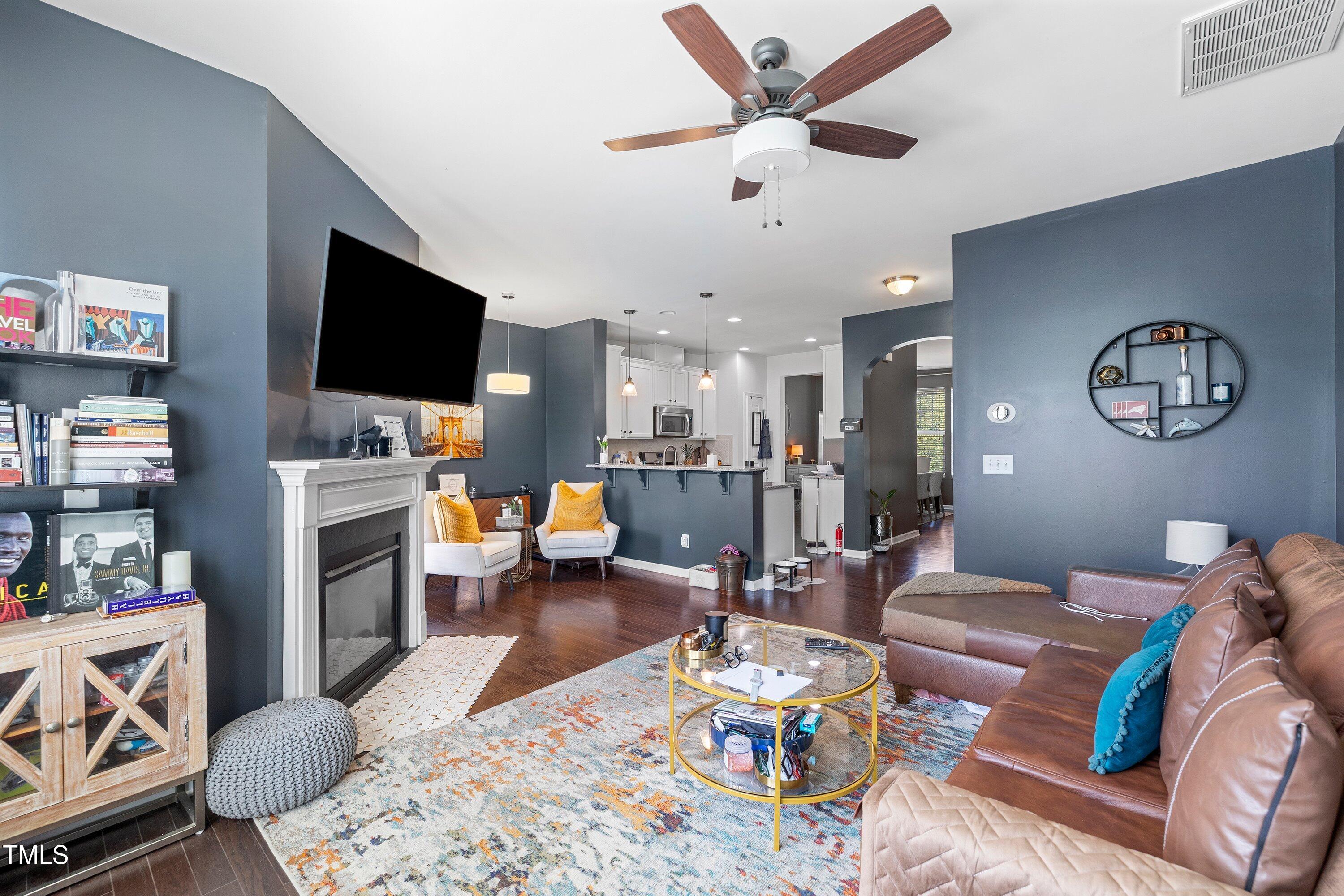 9352 Wooden Road Raleigh, NC 27617 - Photo 10 of 43 a living room with furniture a flat screen tv and kitchen view